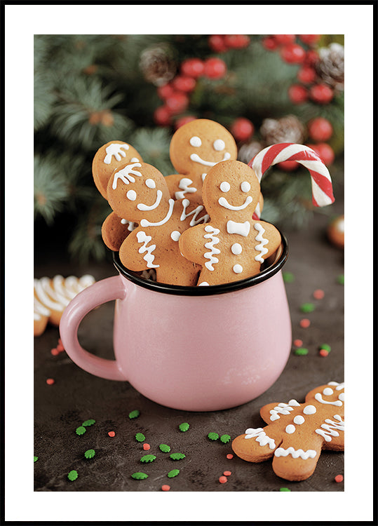 a pink mug filled with cookies and candy canes