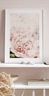 a picture of a pink flower on a shelf