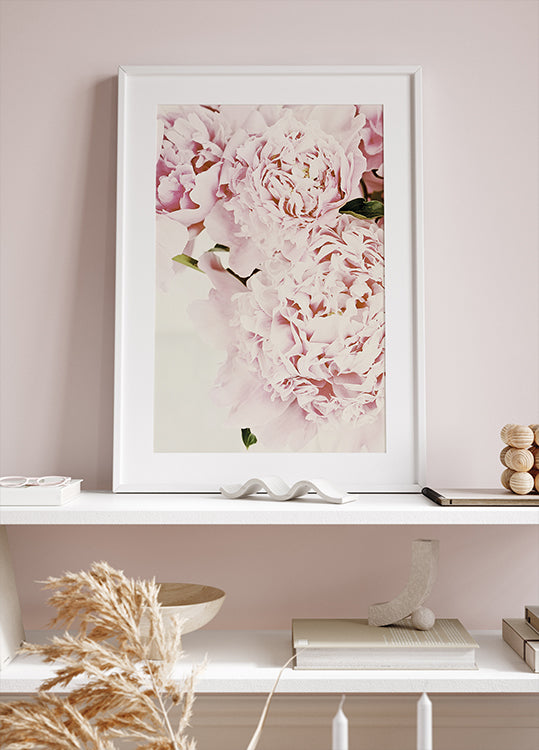 a picture of a pink flower on a shelf