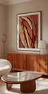 a modern living room with a large abstract painting on the wall, a wooden cabinet, a white sofa, and a glass-topped coffee table.