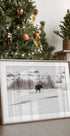 a christmas tree with a picture of a moose in front of it