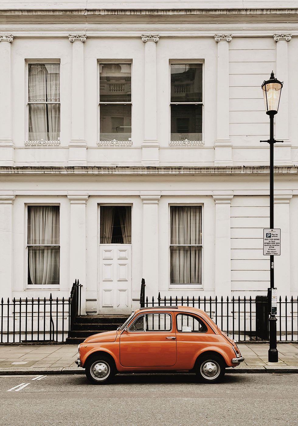 Charming Urban Scene with Orange Car Plakat