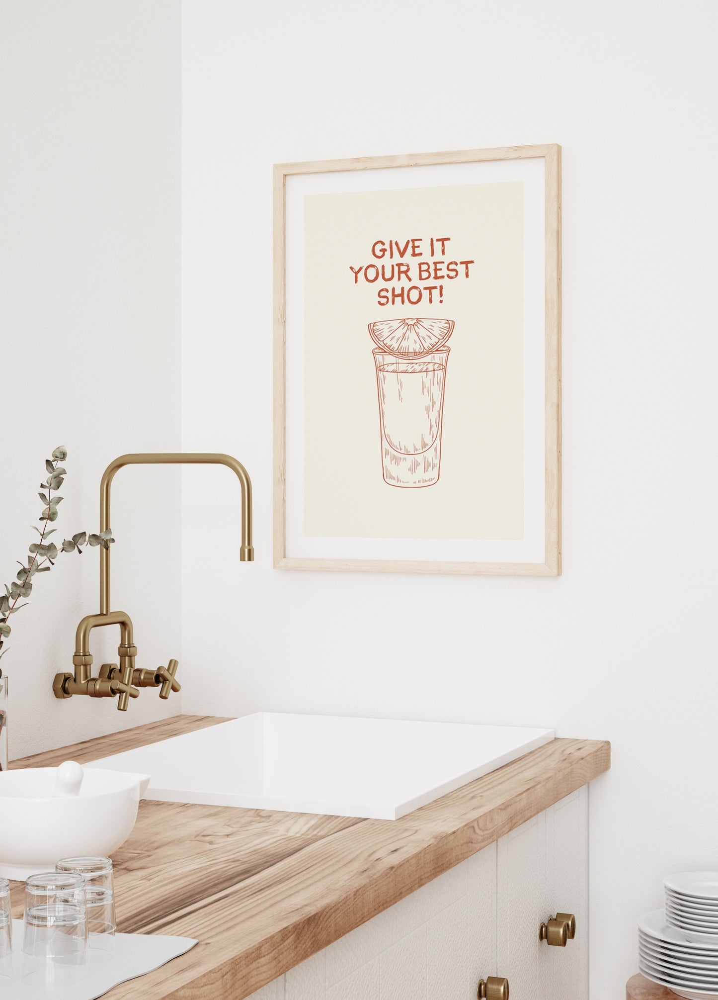 a kitchen with a sink and a picture hanging on the wall