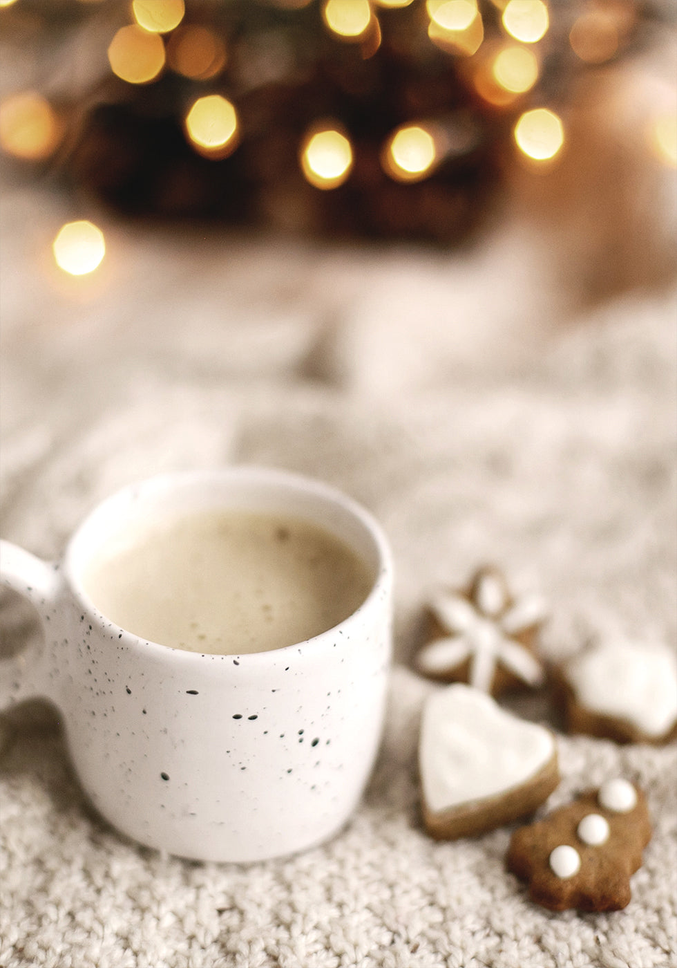 a cup of coffee and some cookies on a table