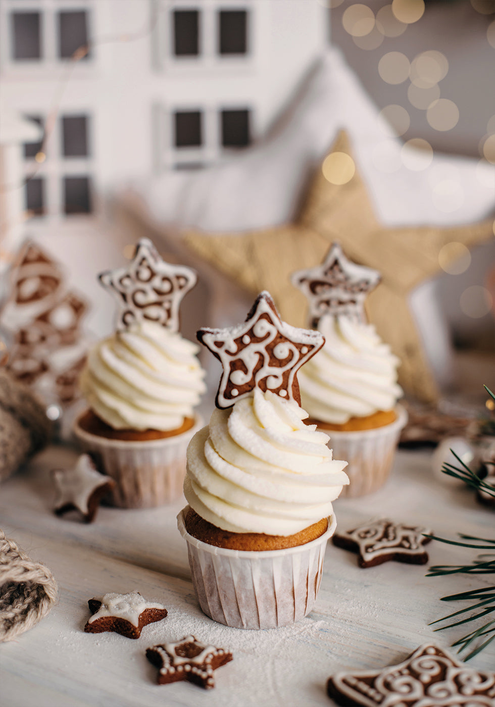 a table topped with cupcakes covered in frosting